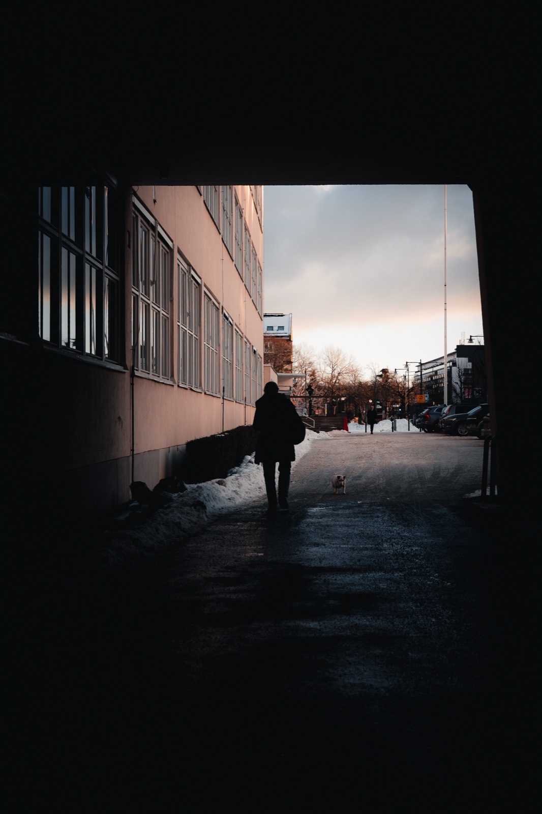 An isolated silhouette leaving a dark covered street