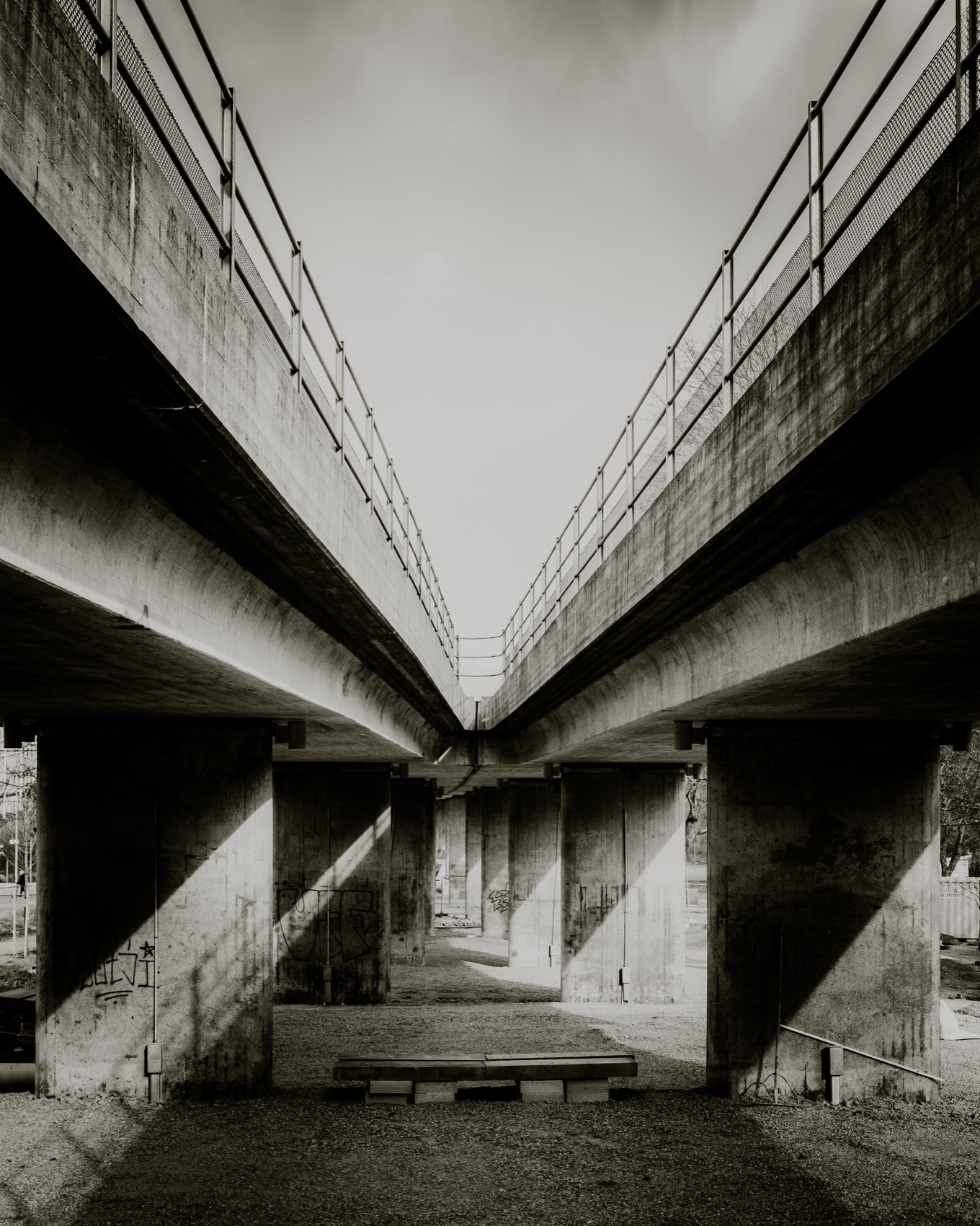 Symmetrical concrete flyovers converging in the distance